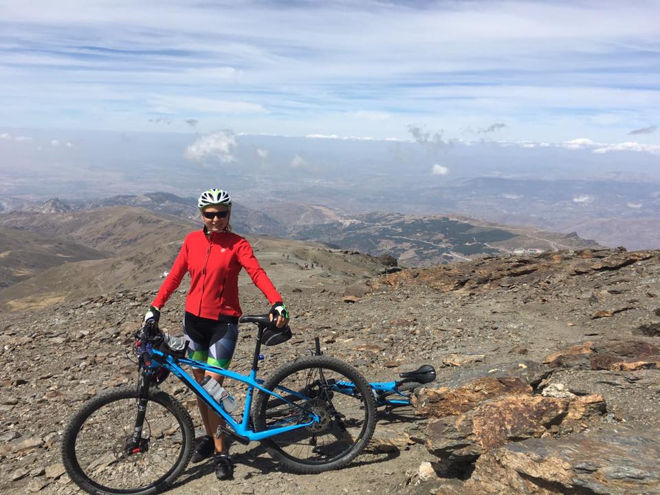 Anna with bike in Spanish mountains.