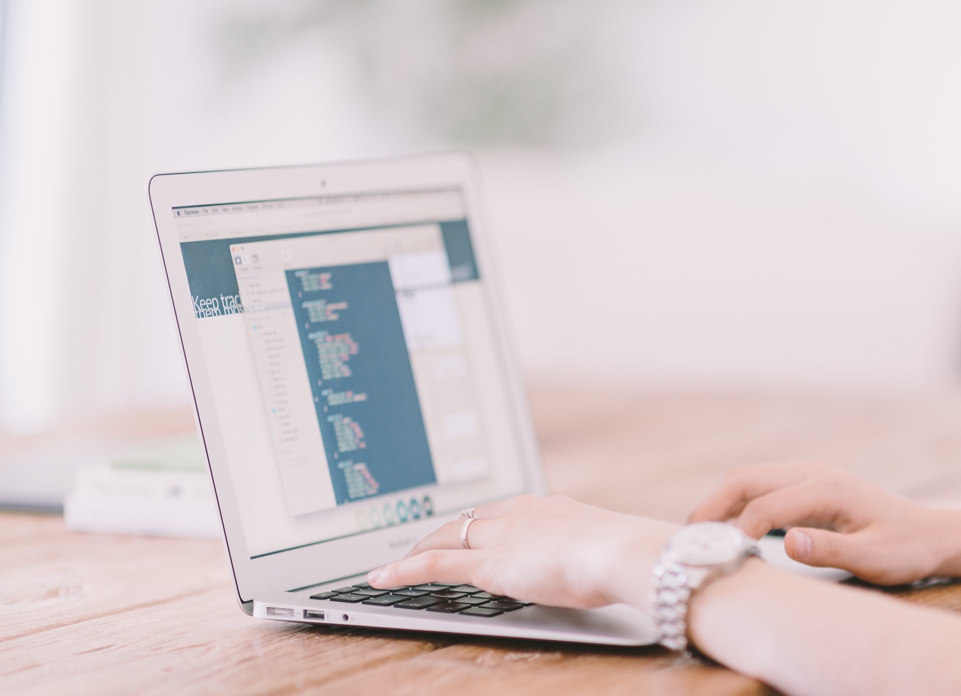 women in translation: woman typing on a laptop