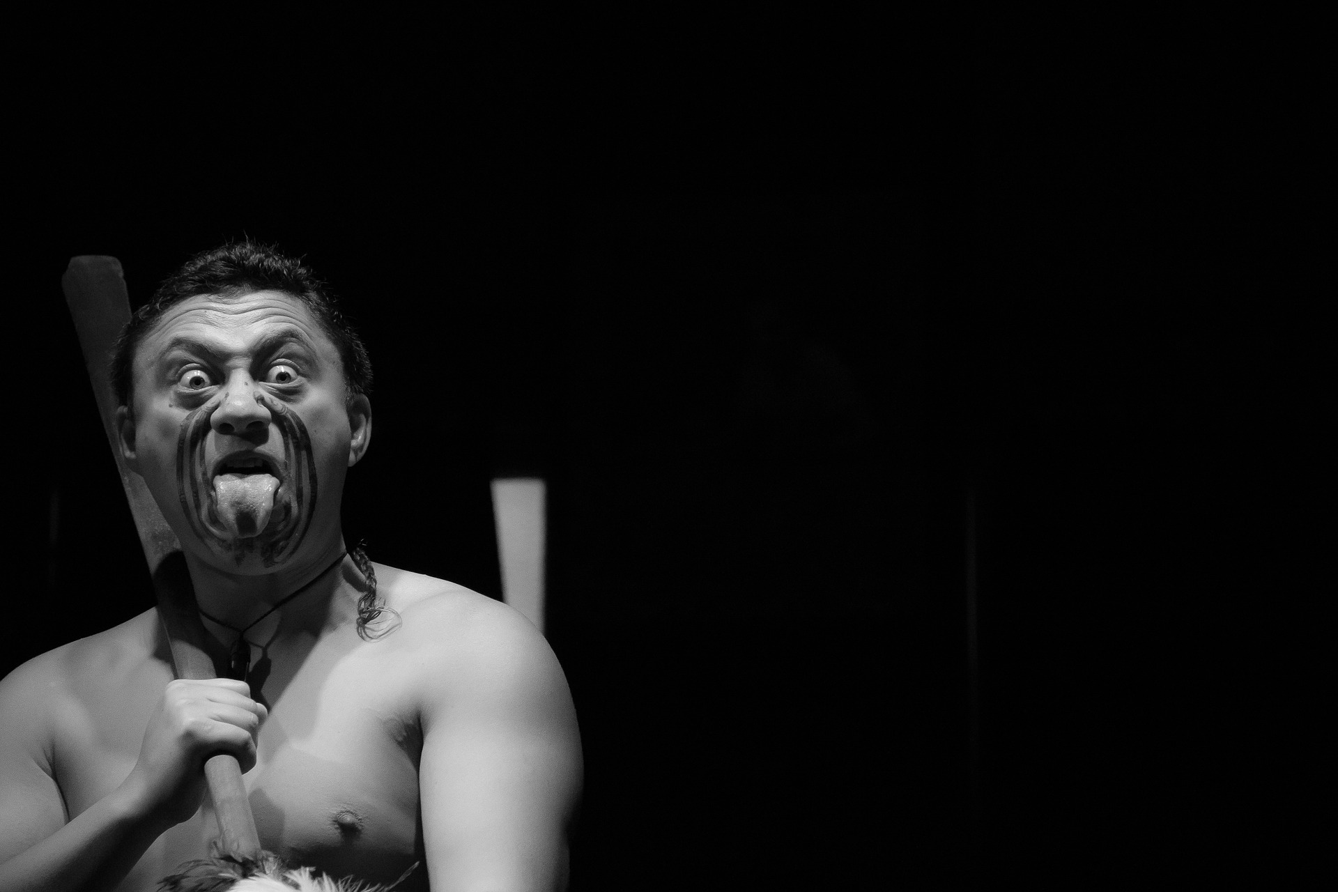 Maori man sticking out his tongue. During Māori Language Week there will be various indigenous events.
