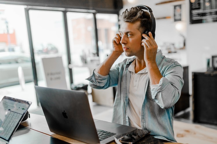 Remote working putting headphones on