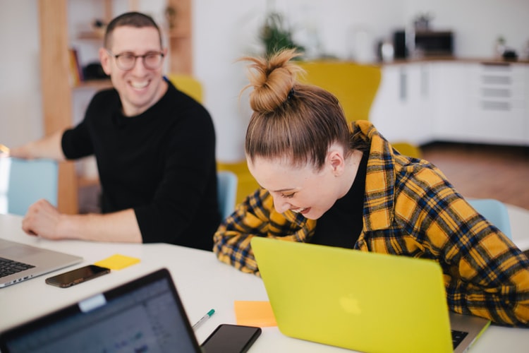 Happy office workers laughing